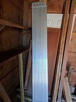 Full view of aluminum scaffold plank leaning against wall