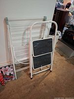 Step stool and drying rack folded against wall