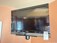 Front view of Vizio TV with remote attached