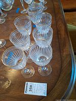 Seven Waterford crystal goblets on table with lot tag visible
