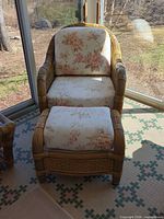 Front view of wicker armchair and ottoman with cushions