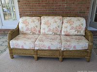 Full front view of wicker sofa with cushions