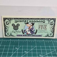 Obverse of 1997 $5 Disney Dollars note showing Tuxedo Goofy, serial number A00147065A