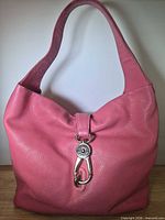Front view of pink leather Dooney & Bourke hobo bag