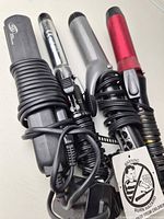 Overview showing four corded hair tools stacked