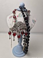 Necklaces displayed on stand showing overall lot contents
