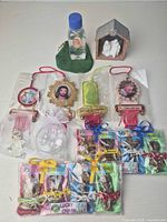 Group view showing all items including nativity, holy water bottle, four hanging plaques, angel charm, bead bag and two Lucky Charm packs