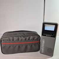 Front view of Sony Watchman FD-20A with screen and antenna beside fabric case