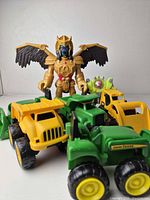 Overall lot showing action figures and three vehicles