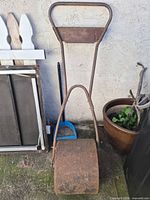 Full view of Toro lawn roller standing upright against wall