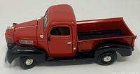 Left side profile of red and black 1:24 diecast 1941 Plymouth pickup truck