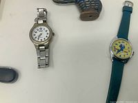 Both watches side by side on table