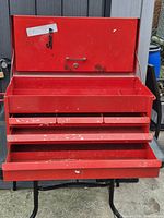 Toolbox front open showing three drawers and interior