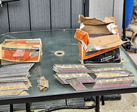 Opened Paslode boxes with collated nails displayed on table