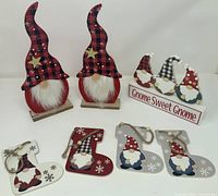 pair of standing gnome figures, sign, and five hanging ornaments