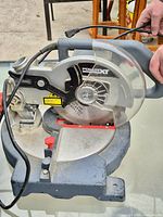 Left side view showing blade guard, motor housing with PowerXT logo, power cord