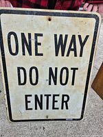 Front view of rectangular metal sign with text