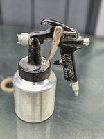 Full view of Campbell Hausfeld spray gun attached to aluminum canister