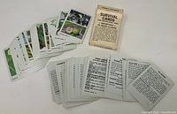 Full spread of survival card deck with box showing photo fronts and text backs