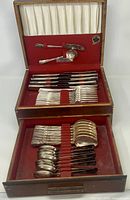 Full view of open wooden flatware chest showing two drawers of utensils