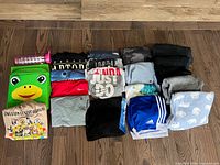 Full lot laid out showing all clothing, storage bins, water bottle