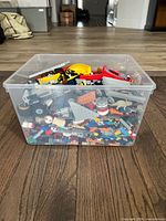 front view of clear bin showing assorted LEGO pieces
