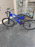 Left side view of complete blue CCM full-suspension mountain bike