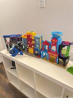 All playset buildings and Batcopter displayed together