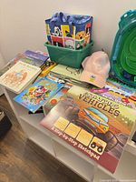 Overall view showing books, cap, sketchpad, caddy and part of Beyblade stadium