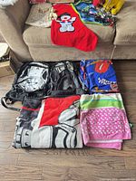 Grouped view showing backpacks, blankets, towel