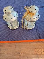 two silver metal glass lanterns top view
