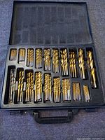 Open case showing full set of gold TiN twist drill bits arranged in molded tray