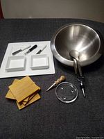 Group shot showing stainless bowl, spoons, ceramic tray with bowls, coasters, glass coaster, wine stoppers, cheese utensils