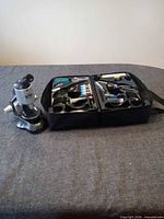Microscope and open carrying case with accessories displayed
