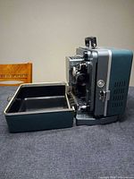 Side view of projector seated in open carrying case
