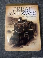 Front of metal tin slipcase showing title and locomotive artwork