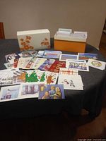 overall view of storage box and spread of greeting cards on table