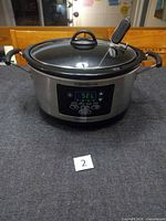 Front view of Hamilton Beach 6-quart stainless steel slow cooker with lid and probe