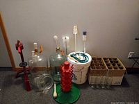 Overall lot showing carboys, capper, bucket, bottle tree, bottles