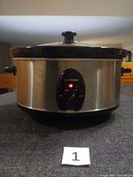 Front view showing stainless steel exterior, control dial, indicator light