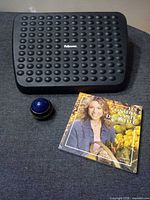 All three items grouped: Fellowes footrest, French health book, blue Harmony Roller