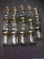 All 14 clear glass jars arranged in rows, lids attached