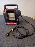 Front view of Mr. Heater Buddy portable propane heater with attached hose