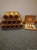 Wicker wine rack next to boxed Laguiole knife set