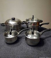 All pots and steamer stacked showing relative sizes