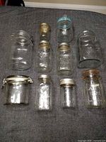 Frontal view of all ten jars showing variety of sizes and closure types