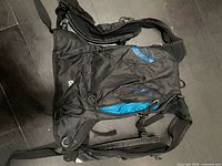 Front view of black Asics running backpack showing logo, zippers, and overall condition