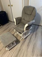 Full view of grey glider chair and ottoman
