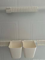 Close view of middle rails with hooks and two bins