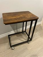 Overall view of rolling side desk showing tabletop, frame and casters